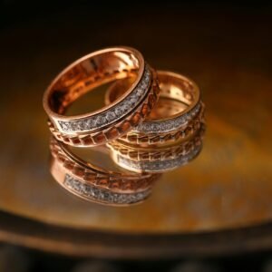 Close-up of luxury gold and diamond wedding rings reflecting light beautifully.